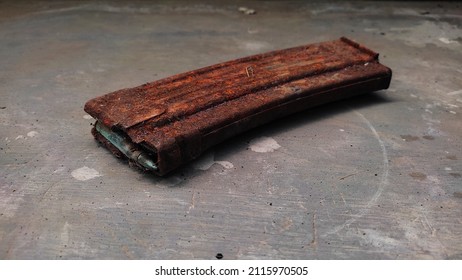 Rusty Gun Magazines On Concrete