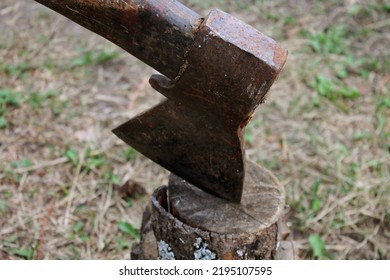 Rusty Hand An Ax Is Driven Into A Tree Against The Background Of Camping Tents, An Ax In A Board, Chop With An Ax In The Forest, Chop Chips For A Fire With An Ax On A Hike, Cut Wood, Splitting Wood