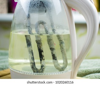 A Rusty, Heated, Scaled Element In An Electric Glass Teapot. The Concept Of  Limescale On The Heating Elements Of Household Appliances.