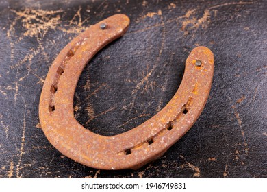 Rusty Horseshoe On An Old Leather Saddle. Good Luck Symbol. Top View