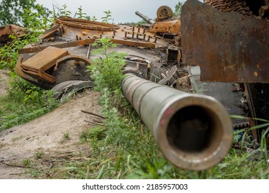 The Rusty Hull Of A Broken Tank Is Overgrown With Grass