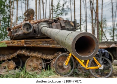 The Rusty Hull Of A Broken Tank Is Overgrown With Grass
