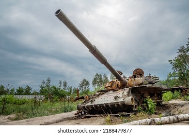 The Rusty Hull Of A Broken Tank Is Overgrown With Grass
