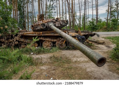 The Rusty Hull Of A Broken Tank Is Overgrown With Grass
