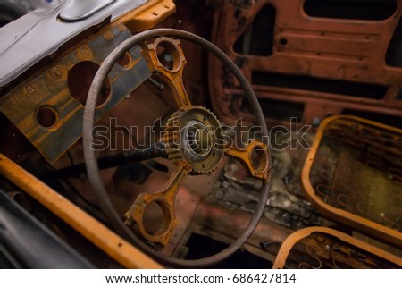 Rusty interior of an old car. Close up of Car steering wheel and dashboard panel with rust and dust.