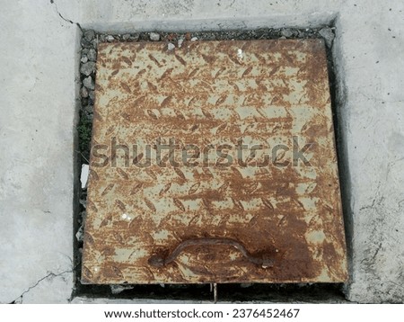 rusty iron plate with cement cast floor in the background