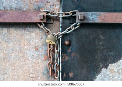 Rusty iron shutter gate and chain locked