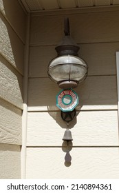 A Rusty Light Fixture Hanging Outside In A Corner