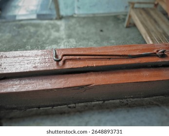 Rusty locking latch on a dirty and dusty window
