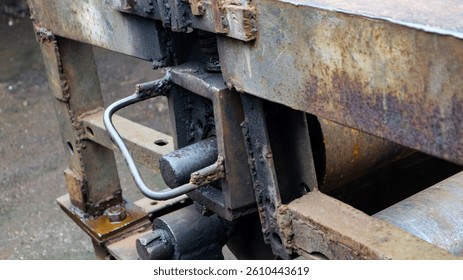 A rusty machine that has many weld joints.
