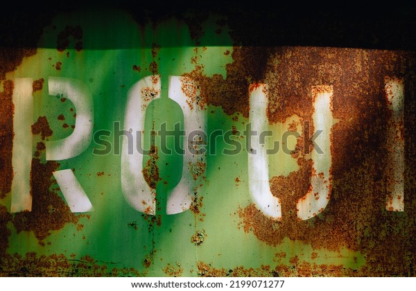 Rusty metal\
background, texture. Iron background - wall of an old rusty freight\
car, green in color almost completely covered with brown rust with\
white stenciled letters R, O, U,\
I