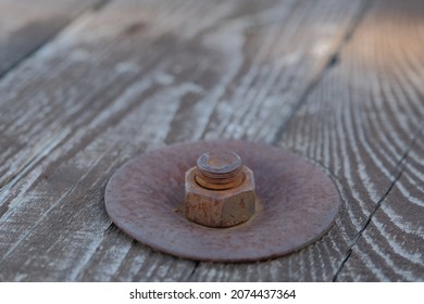 Rusty Metal Bolt. Rusty Metal Bolt And Nut On Wooden Surface