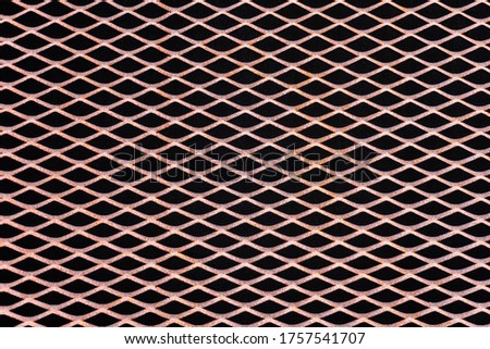 Rusty metal grid with geometric pattern of rhombi, background