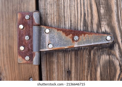 Rusty Metal Hinge On Wooden Gate