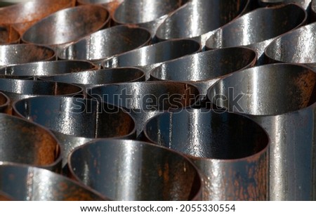 rusty metal pipes lined up decoratively