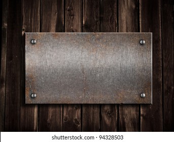 Rusty Metal Plate On Wooden Background