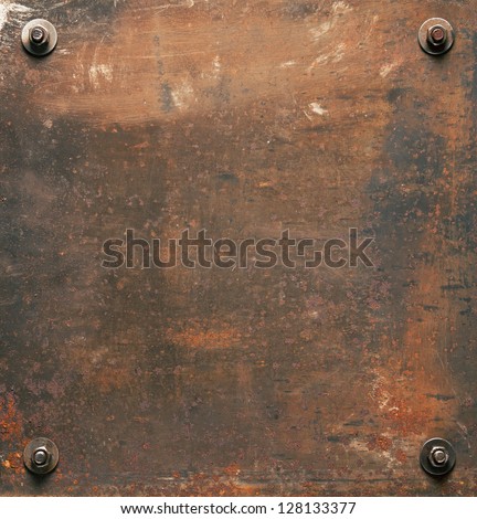 Rusty metal plate texture with bolts.