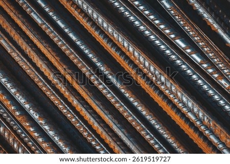 Rusty metal rods arranged in a patterned structure showcasing texture and wear captured in warm light during the afternoon hours