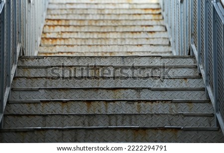 Rusty metal stairs inside an industrial park.
