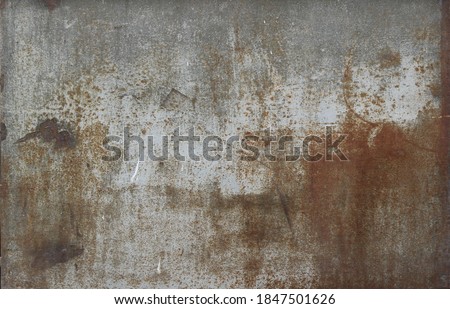 rusty metal surface with gray and light brown tones - worn steampunk background with scratches and grooves	