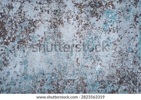 Rusty metal texture background with peeling blue paint closeup. Weathered corroded iron surface with flaking light blue paint layers and brown rust spots, old industrial rustic wall material for grunge design backdrop.