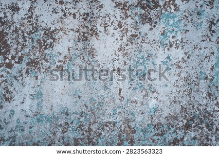 Rusty metal texture background with peeling blue paint closeup. Weathered corroded iron surface with flaking light blue paint layers and brown rust spots, old industrial rustic wall material for grunge design backdrop.