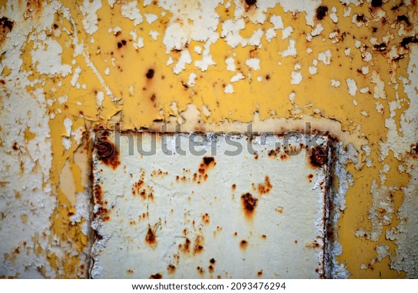 Rusty metal wall painted with paint. Rusty metal\
background with streaks of\
rust.