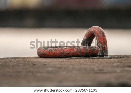 Rusty mooring ring at a port.