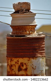 Rusty Oil Drum With Car Rims And A Rock On Top Slightly Blurred To Convey Sense Of Softness Against The Rough Metal Surfaces 