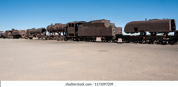 Rusty old and abandoned trains at the Train Cemetery (Cementerio de Trenes) in Uyuni desert, Bolivia - South America - Shutterstock ID 1171097209