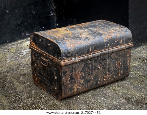 Rusty old\
antique travel trunk, coffer.\
Metal.