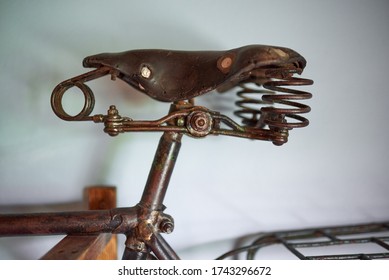 Rusty old bicycle hanging on a white wall