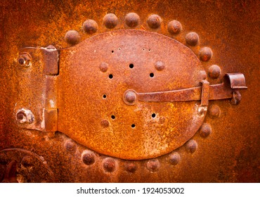 Rusty old boiler door. Industrial revolution large rivet heads. Industrial background.