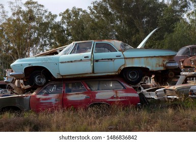 Rusty Old Cars From The 1950s And 1960s Abandoned In A Wrecking Yard Car Graveyard In Rural Australia.