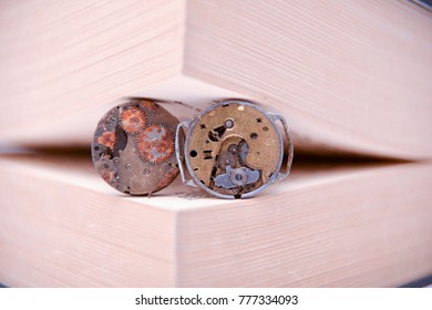 rusty old clock mechanism between book pages, concept