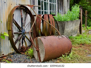 Rusty Old Farming Equipment Against Old Shed