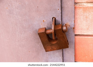 A Rusty Old Padlock Is Locked On Metal Doors. No Entry, Security.