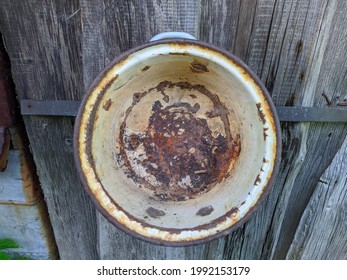 Rusty And Old Saucepan On Wooden Background