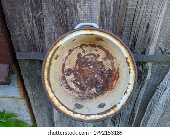 Rusty And Old Saucepan On Wooden Background