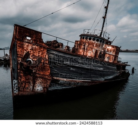 rusty old ships sitting in a junkyard