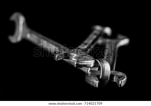 Rusty, old workshop keys. Hydraulic keys on a\
black table in a\
workshop.