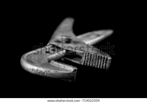 Rusty, old workshop keys. Hydraulic keys on a\
black table in a\
workshop.
