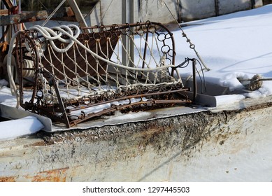 Rusty Oyster Dredge Sitting On Edge Of Deck Of Oysterboat, Maryland Eastern Shore