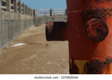 Rusty pipe on the seashore. Background with free place for your text