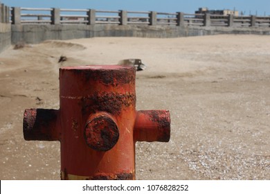 Rusty pipe on the seashore. Background with free place for your text