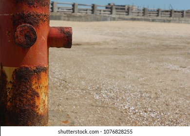 Rusty pipe on the seashore. Background with free place for your text