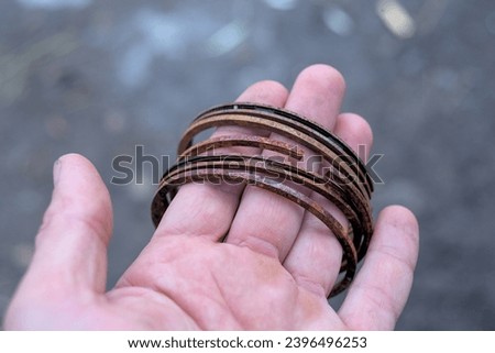 Rusty piston rings in the hands of a car mechanic close up