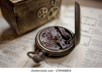 A Rusty Pocket Watch With A Broken Mechanism Is Lying On The Table.