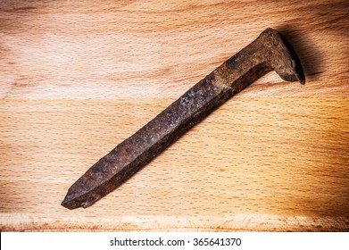 Rusty Railroad Big Nail On Wooden Background