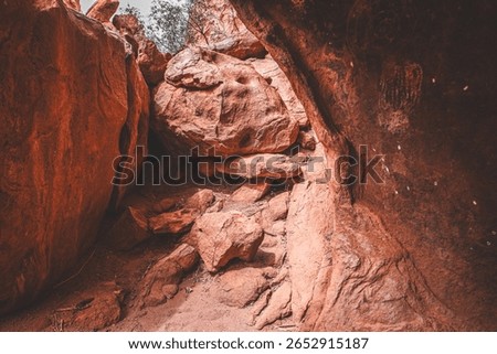 Rusty Red Cave Formations with Aboriginal Rock Art near Uluru, Australia
